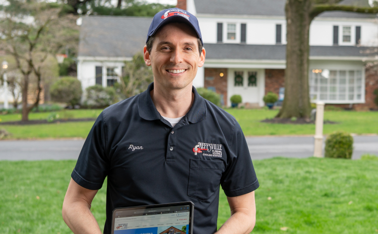 a home service technician standing in front of a home