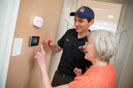 Neffsville technician and homeowner checking a thermostat