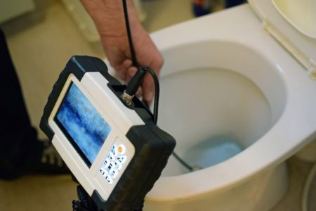 Video Camera Inspection tool being used in a toilet