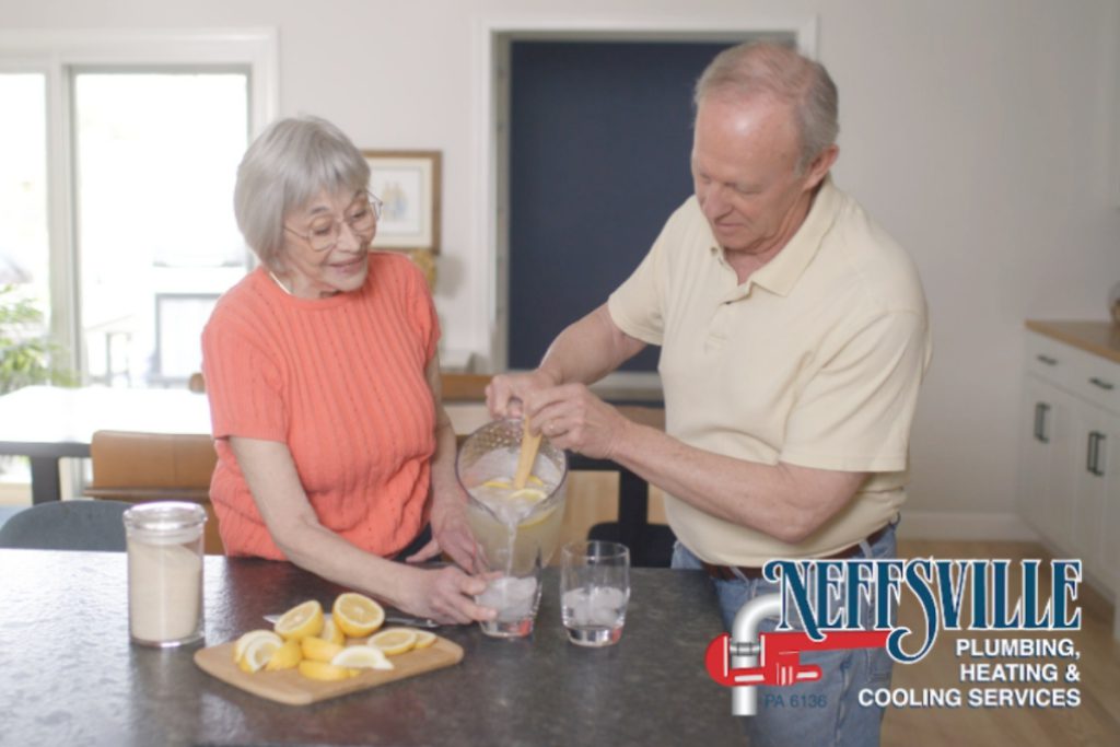 Elderly couple pouring glasses of lemonade