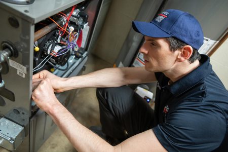 Technician inspecting furnace