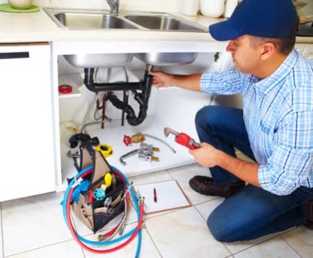 Neffsville employee working on kitchen sink pipes